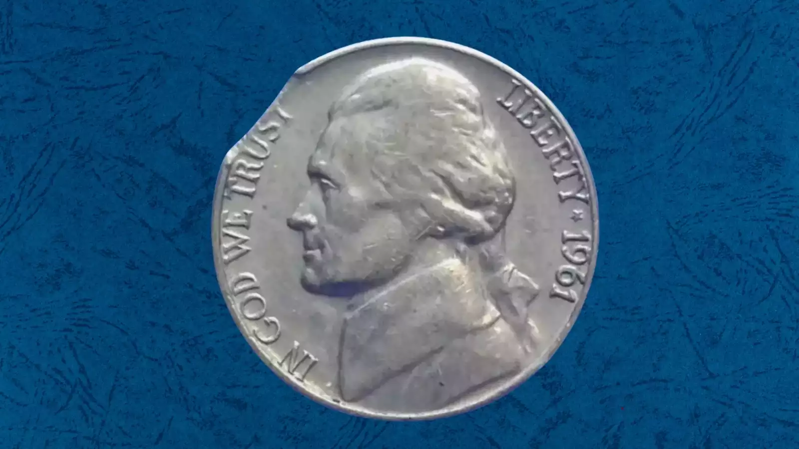 1961 nickel clipped planchet error showing curved missing section along coin edge