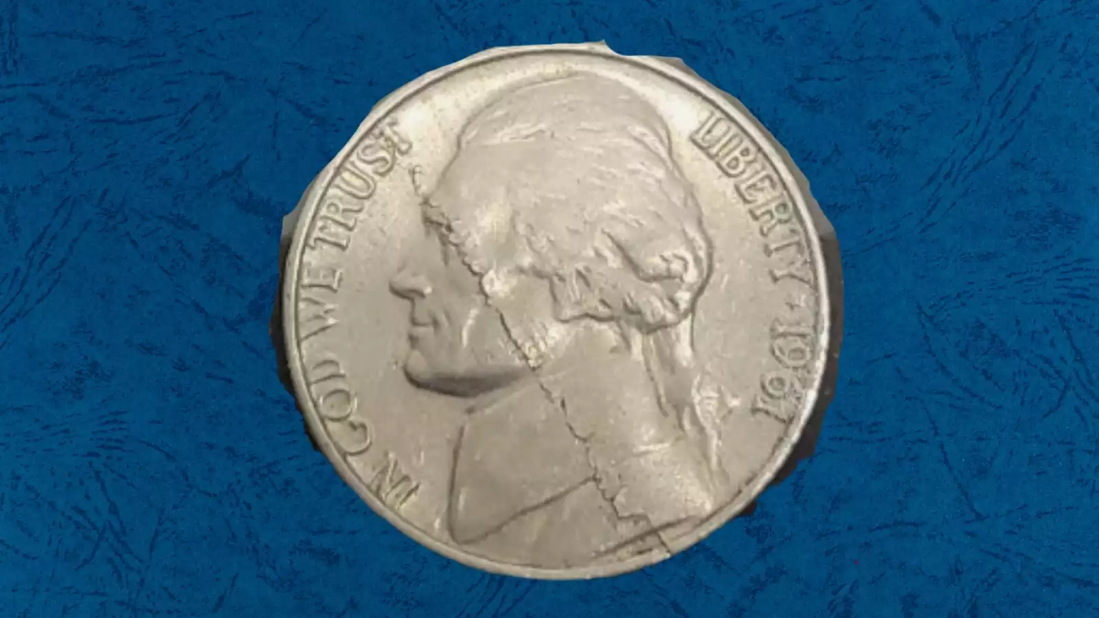 1961-D nickel bar die break error showing raised metal ridge across LIBERTY and date area on obverse